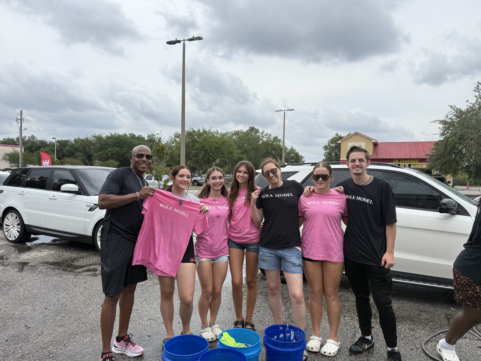 Role Models Foundation volunteers in Role Model shirts at a car wash fundraiser