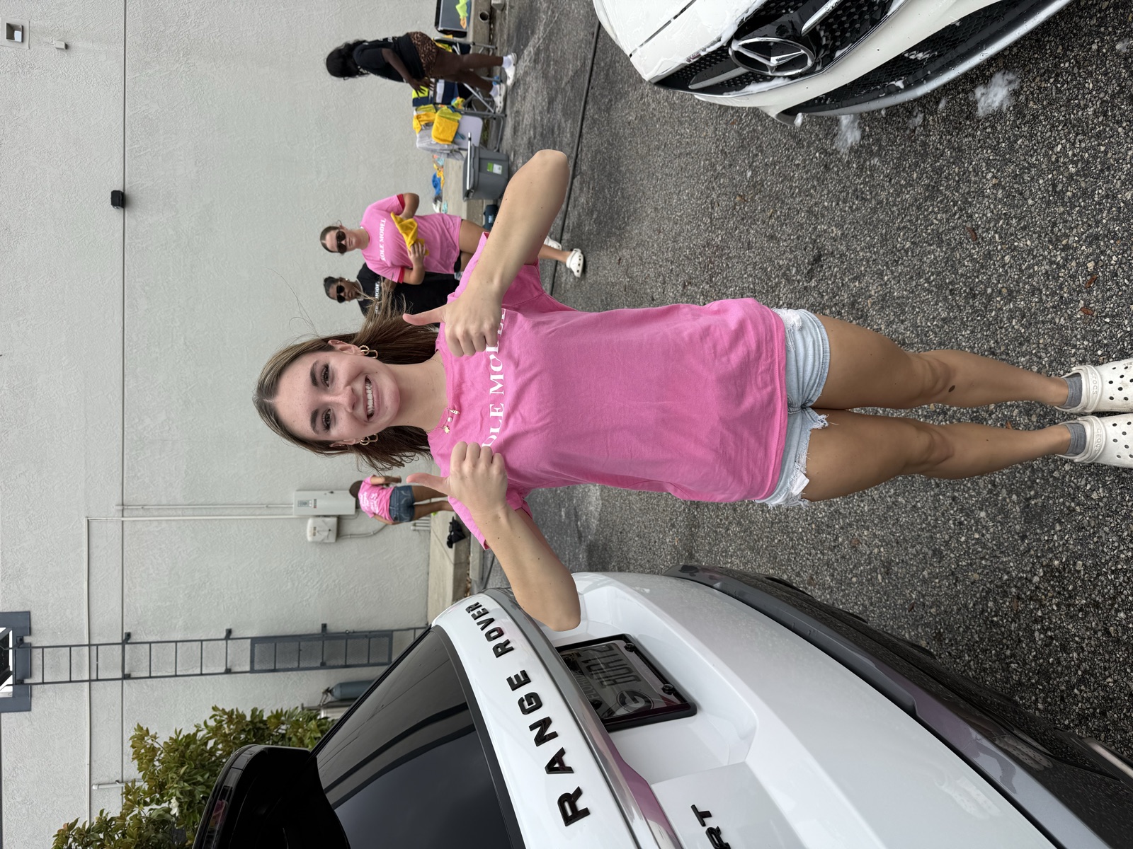 A young volunteer in a Role Model shirt at the car wash fundraiser