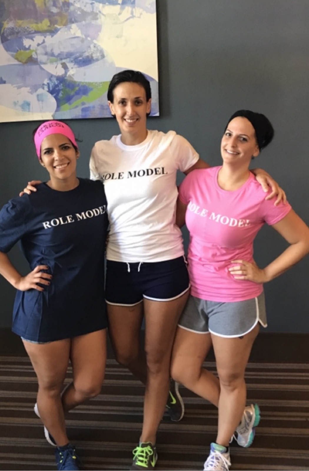 Three women wearing Role Model t-shirts