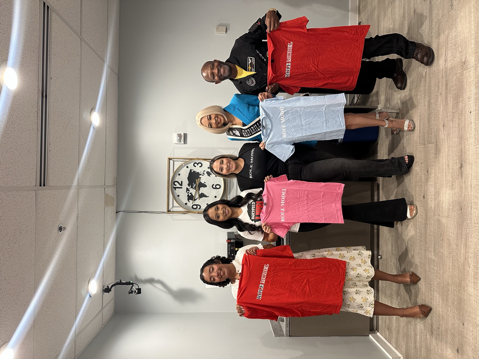 Role Models Foundation supporters holding up Role Model shirts